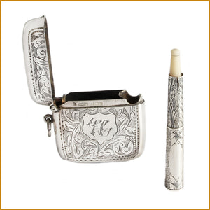 a beautiful engraved vesta case with cigarette holder 