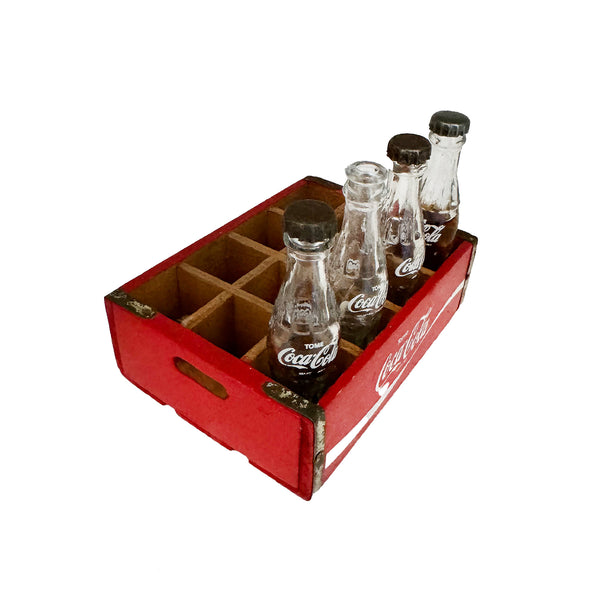 A 1950s to 1970s vintage original Coca Cola crate and 4 bottles in miniature