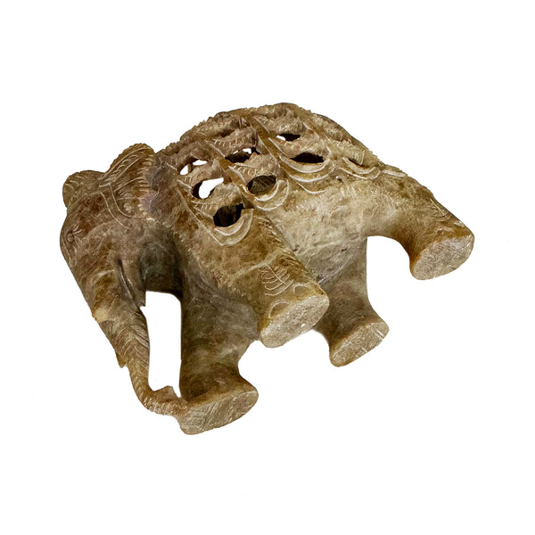 a carved elephant with baby inside figure 