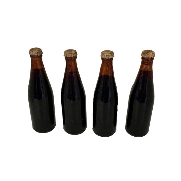 4 miniature glass guinness bottles with tops