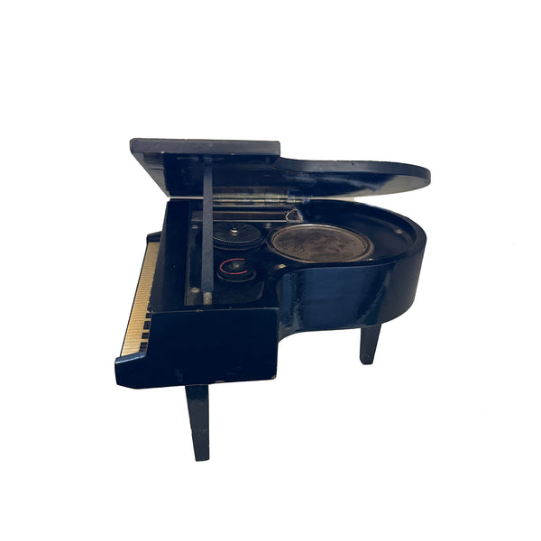 A black painted wooden miniature grand piano with 6 transistor radio