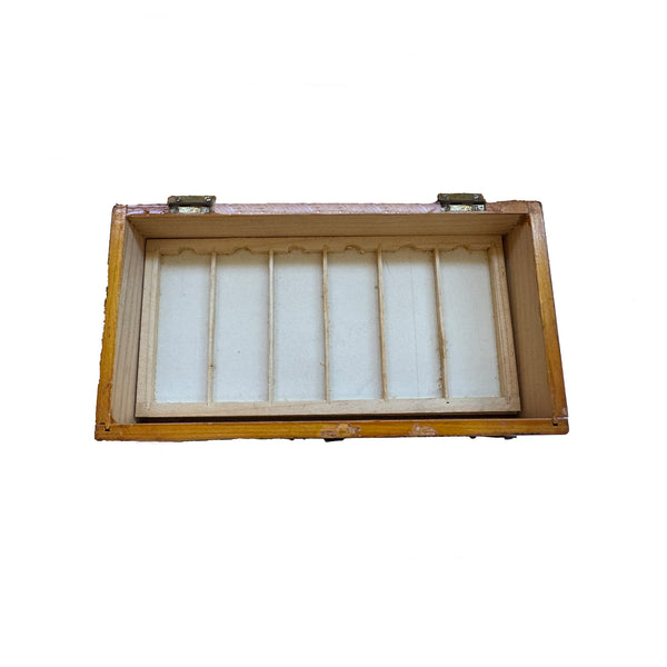 An empty tray of microscope slides in a wooden box