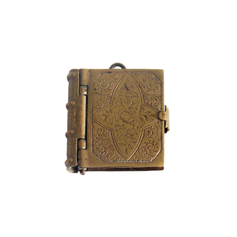 A miniature brass patterned photo album with hinge