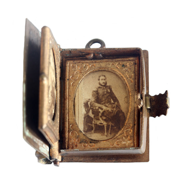 A miniature antique old brass photo album with a gentleman portrait