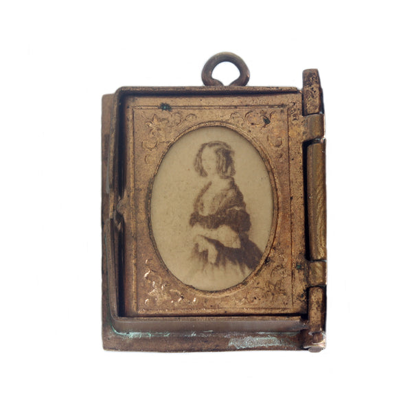 A miniature portrait of a lady in victorian dress oval frame in brass album