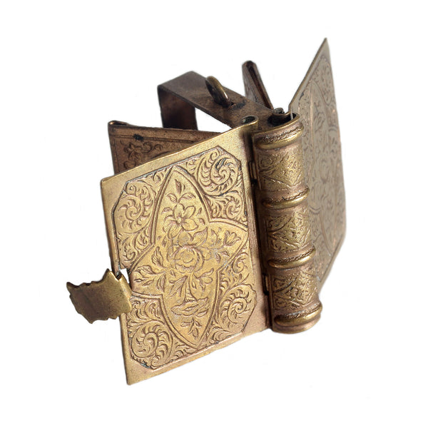 A beautiful brass miniature photo album with portraits inside