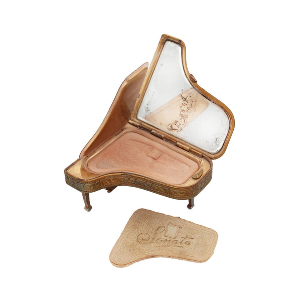 A secondhand novelty opening grand piano powder compact