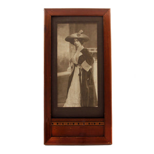 A victorian portrait of a lady in a brown art deco design frame