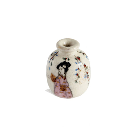 A beautiful painted miniature vase of a japanese geisha lady with flowers