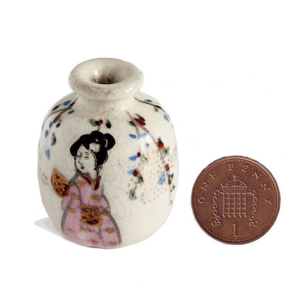 A very small miniature porcelain vase with japanese lady and flowers