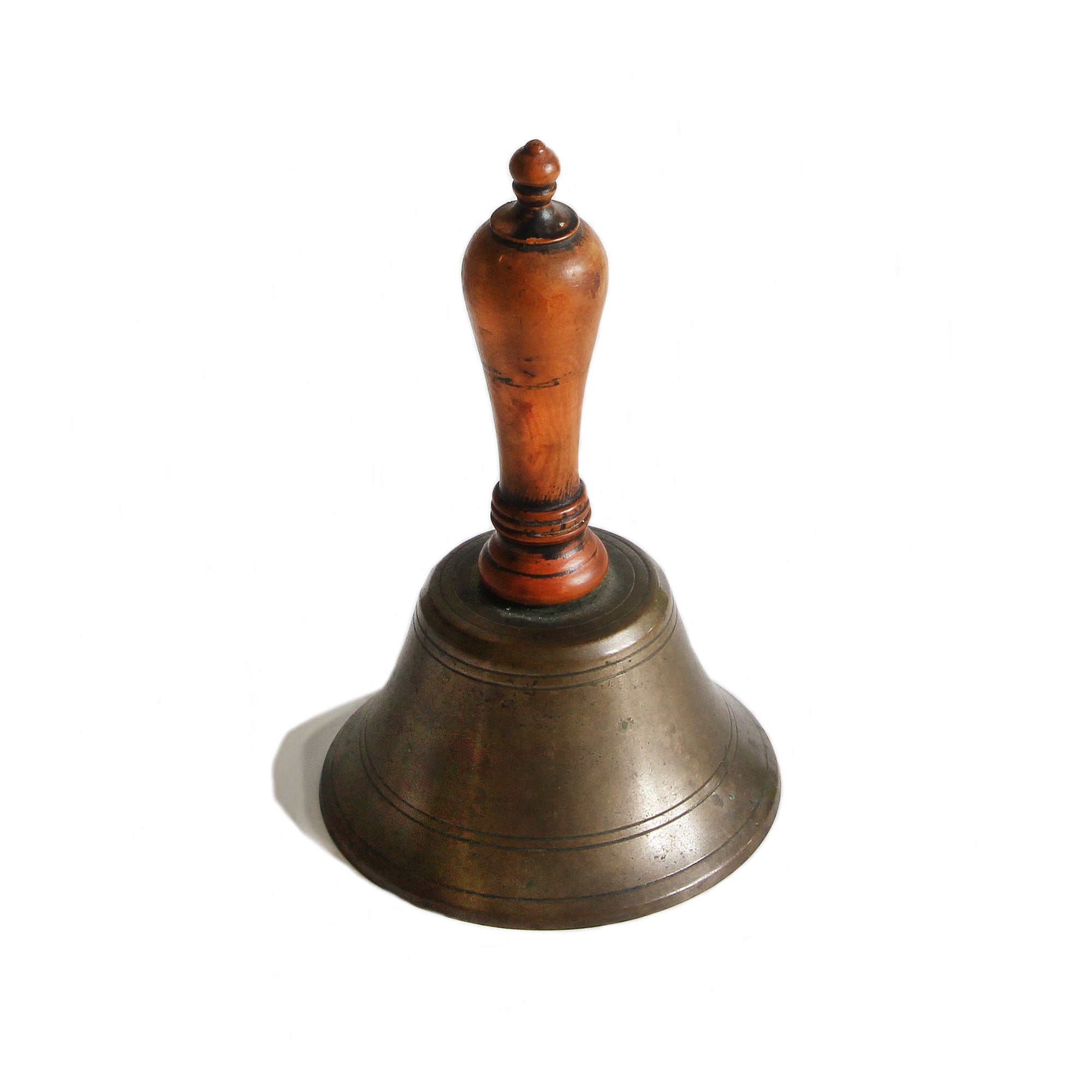 A vintage old school bell with wooden handle and brass base in miniature