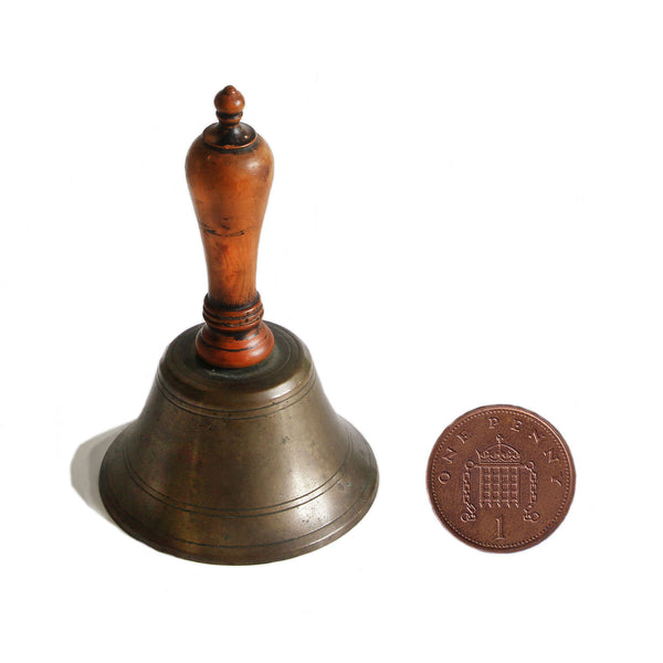 A vintage old miniature school bell made from brass and wood