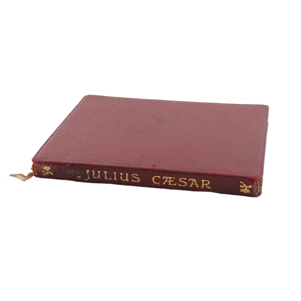 A secondhand little Julius Caesar book with red cover and illustrations dated 1903