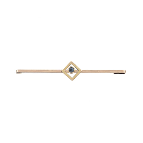 A secondhand gold bar brooch with a central blue sapphire in a square border