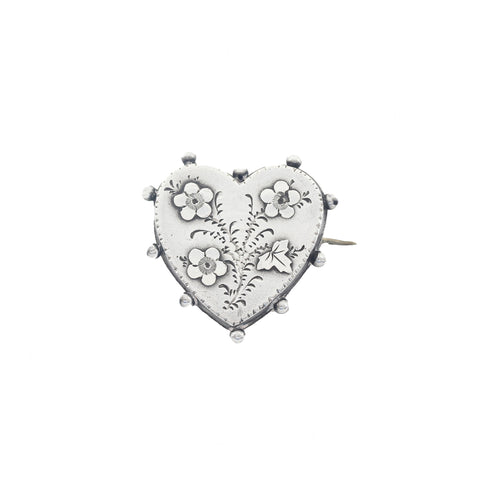 A beautiful silver heart shape floral brooch dated 1894