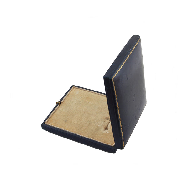 A navy medal display box with gold trim edge by Spink and Son