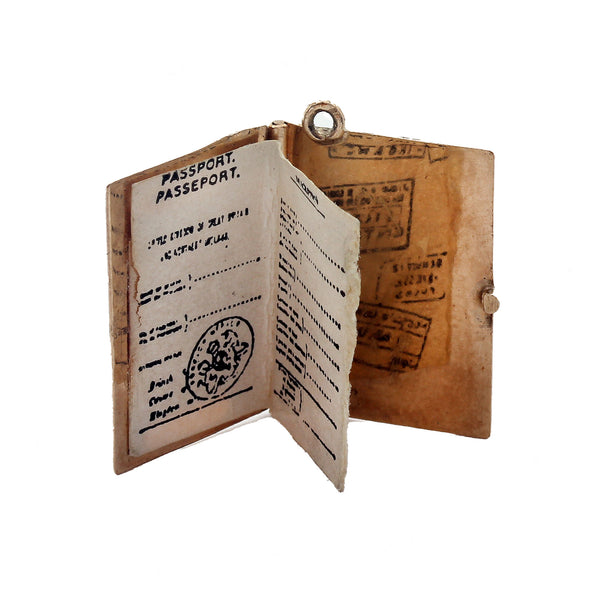 A 1969 gold passport charm which opens up revealing papers