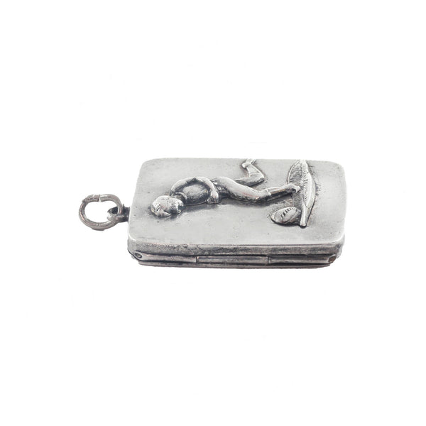 A silver secondhand antique rectangular pendant with footballer on front