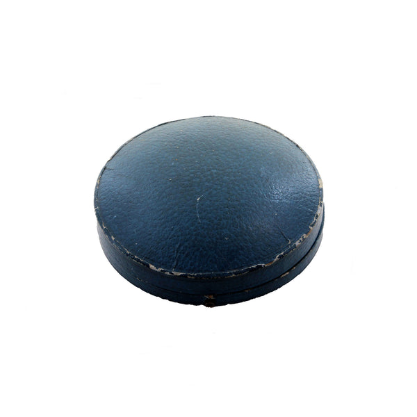 A blue leather round box with collar studs inside and the fittings