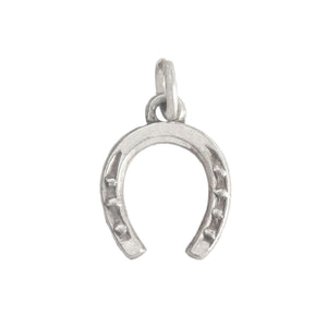 A vintage sterling silver detailed horseshoe charm with jump ring