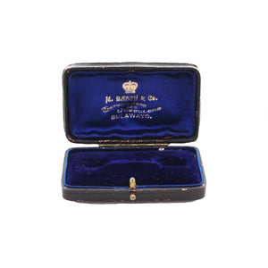 A vintage brooch display box with blue velvet inside M Basch & Co jewellers