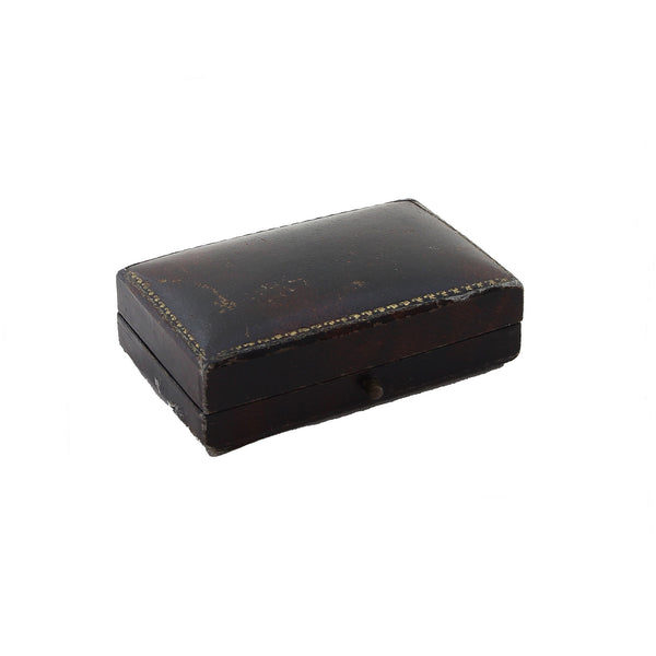 A preowned brooch box rectangular with gold trim detailing outside 