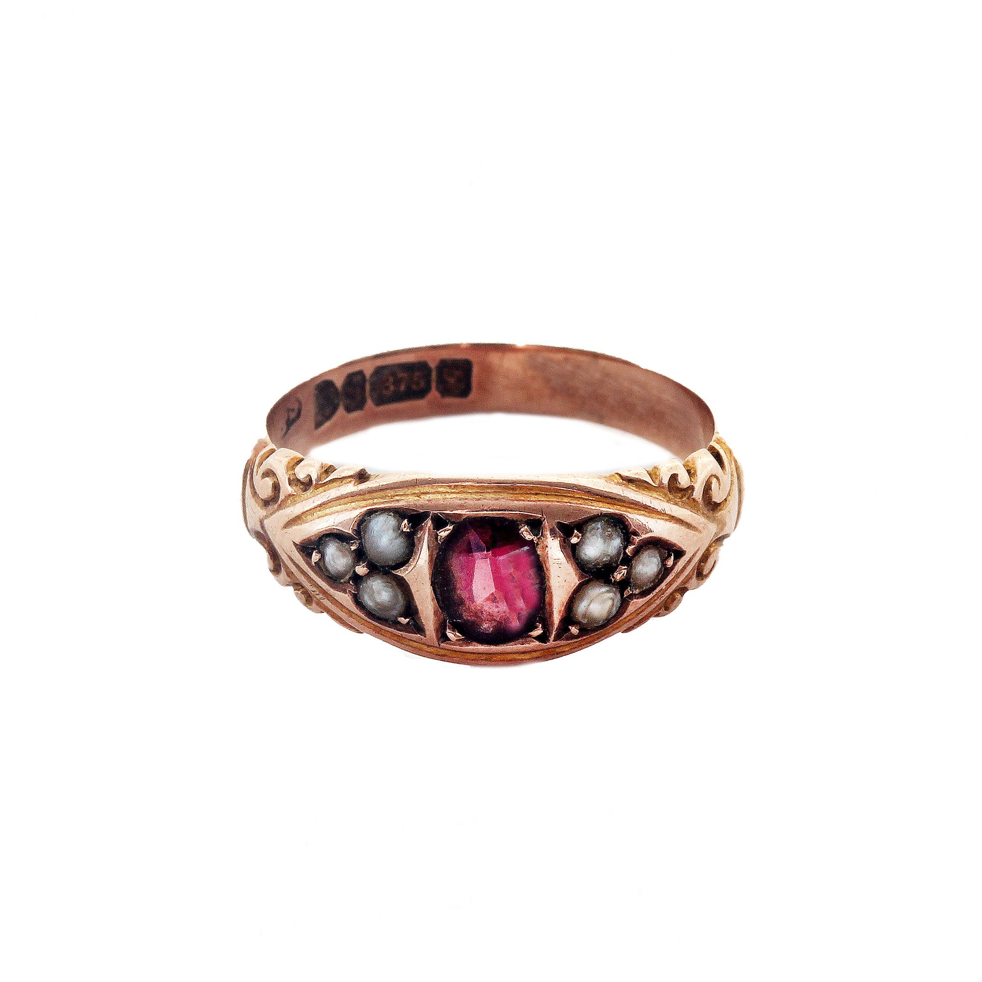 An antique garnet and seed pearl ring in 9 carat rose gold swirl decoration 