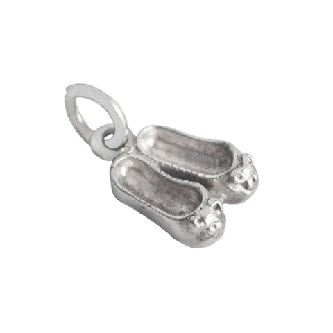 A pair of tiny ballerina shoes in sterling silver for a charm bracelet