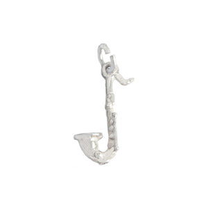 A vintage small saxophone charm in sterling silver