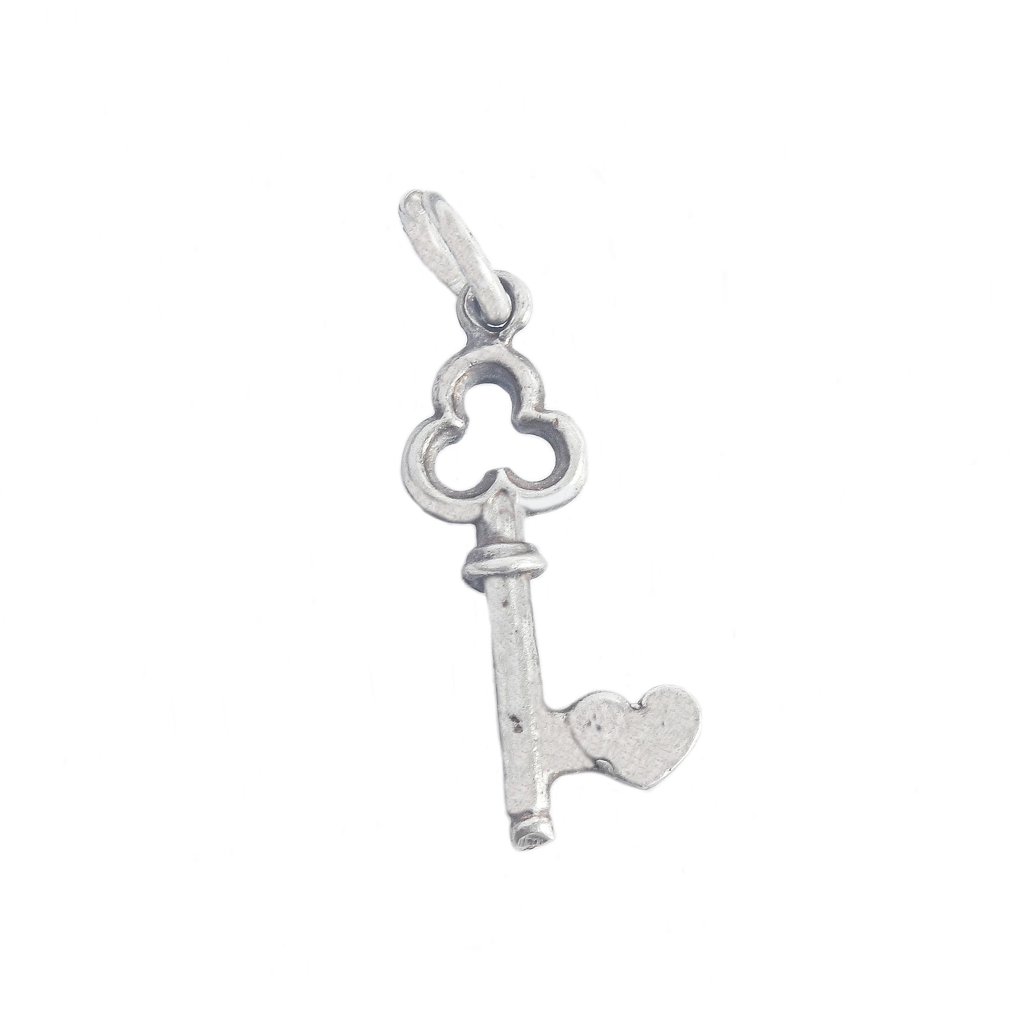 A secondhand sterling silver key charm with a heart on the side