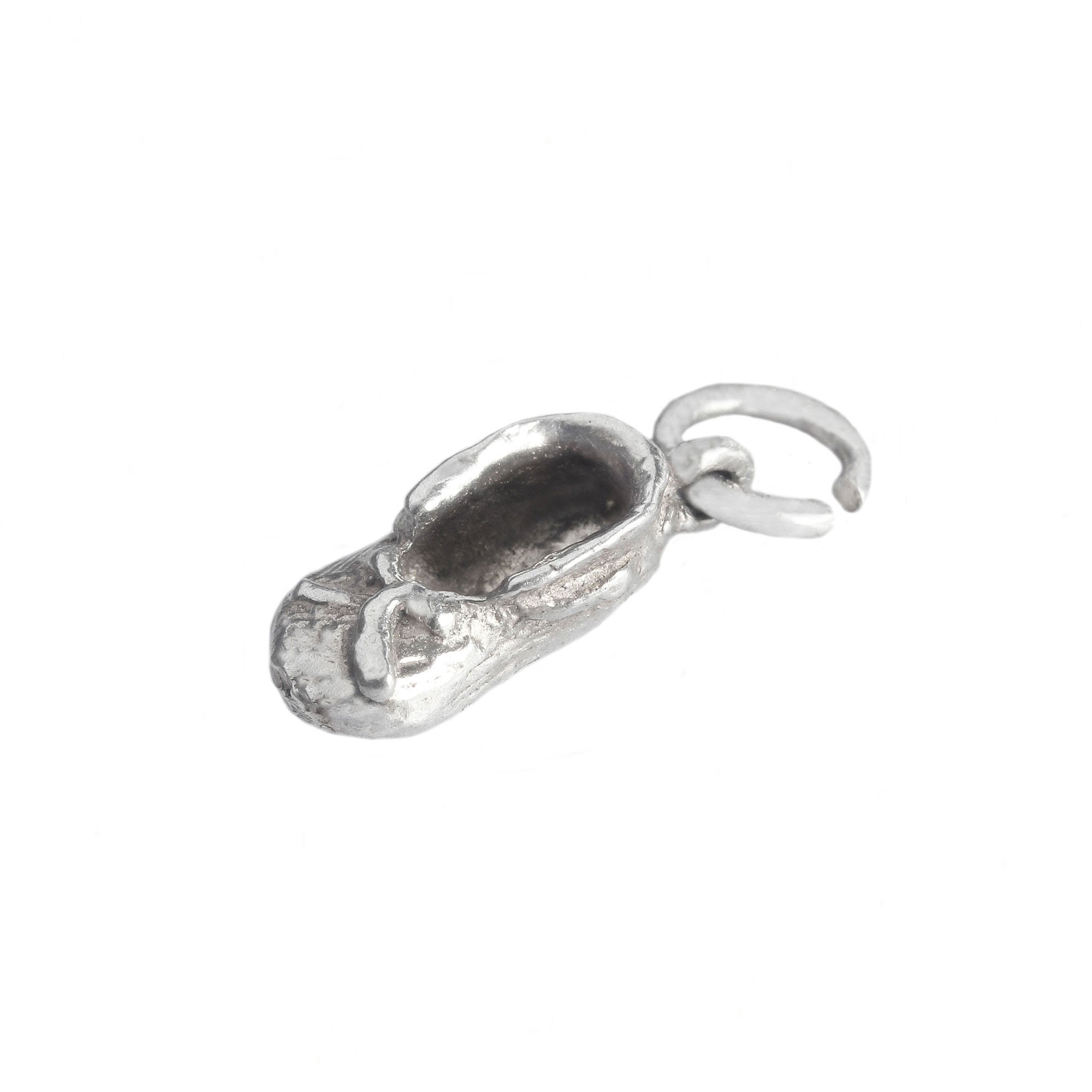 A sterling silver small right slipper with tie charm