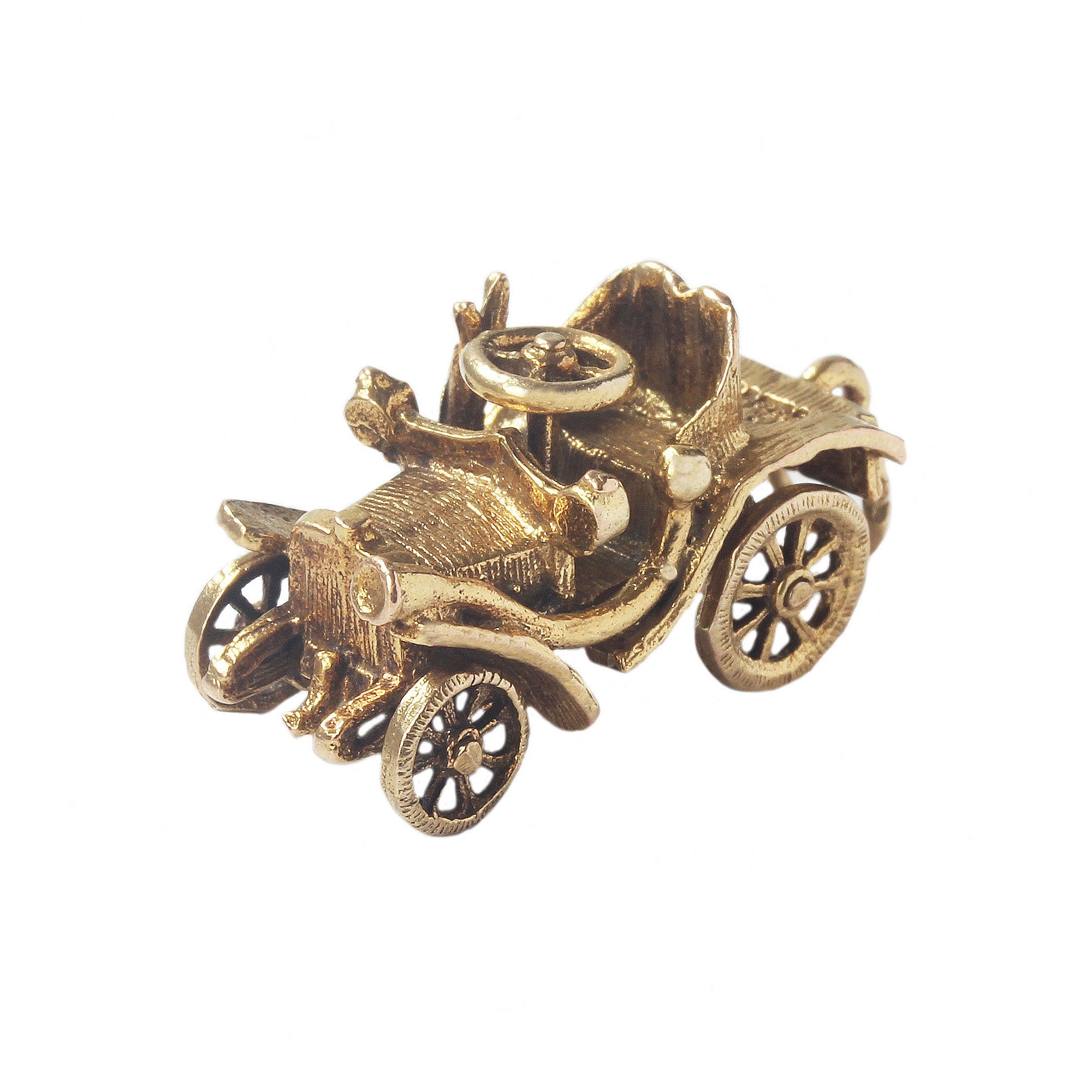 An old open top car with moving wheels made in yellow gold