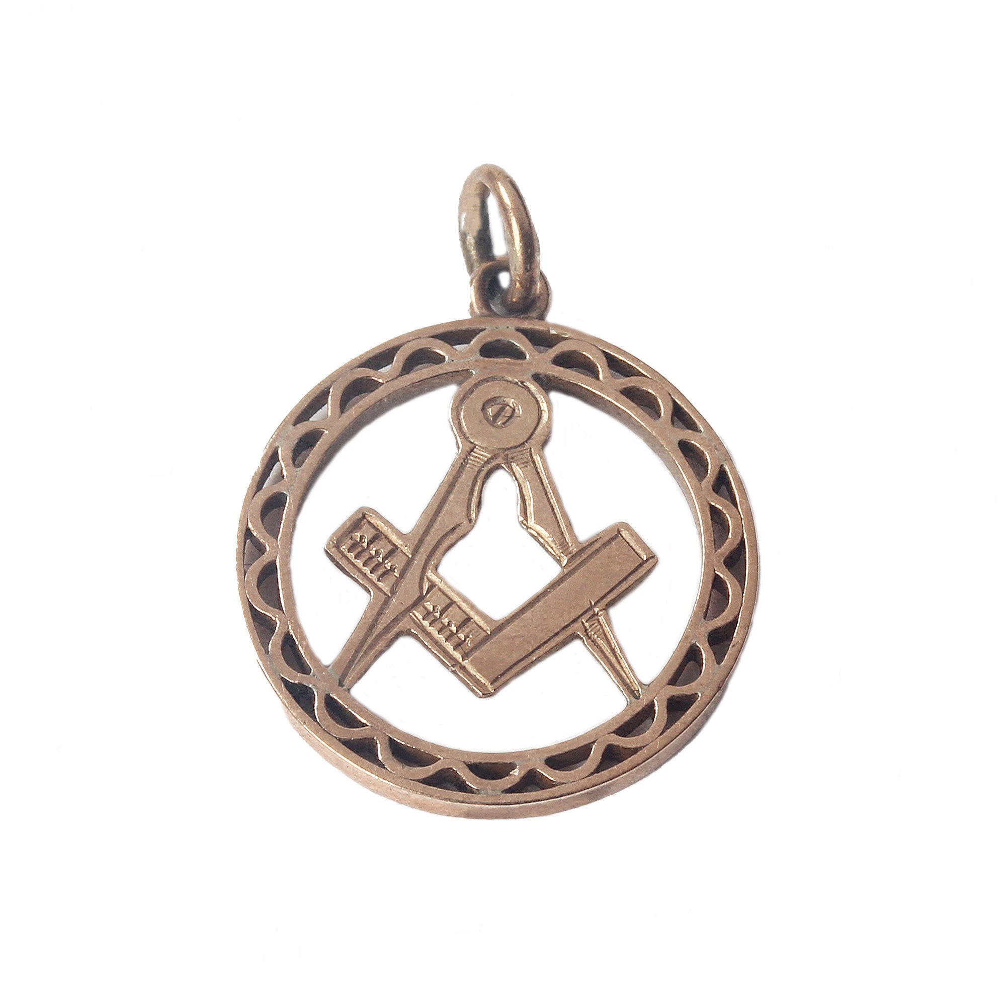 A rose gold circular masonic pendant with patterned border edge stamped 9CT