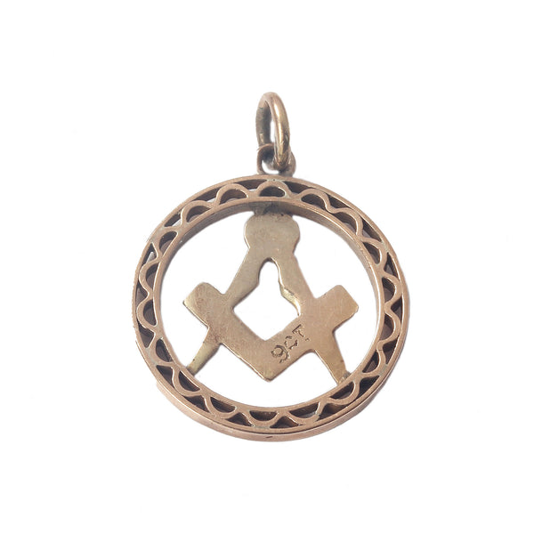 A vintage rose gold round cut out masonic pendant