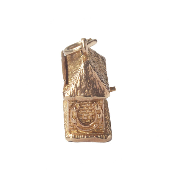 A vintage 1960s gold blacksmith moving charm with Birmingham hallmark