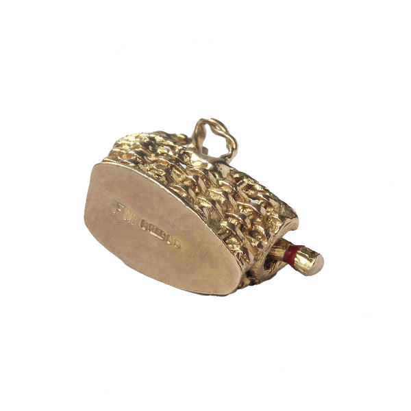 A hallmarked London 1960 wine bottle and basket charm