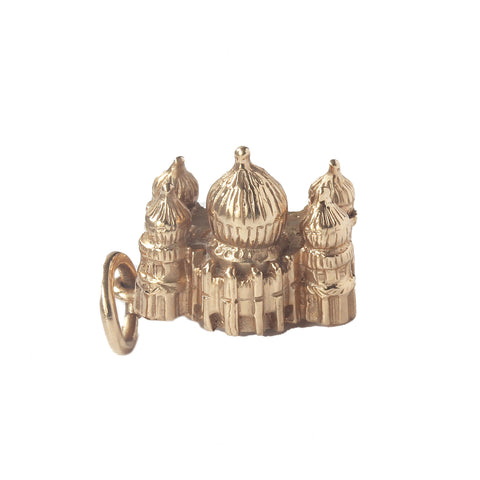 A solid vintage royal pavilion charm in 14 carat yellow gold