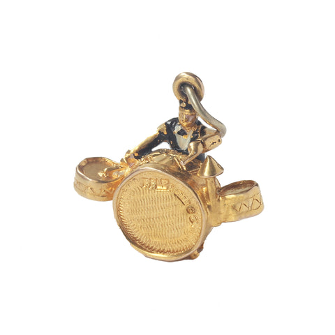 A 1950s yellow gold vintage charm man playing the drums hallmarked Birmingham 1953