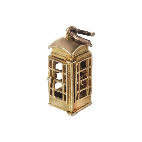 A gold vintage telephone box charm large in size with opening door