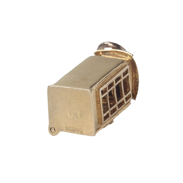 A telephone box vintage gold charm with opening door and phone inside