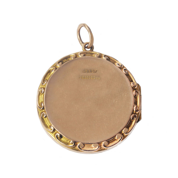 An antique hallmarked round patterned edge locket for 2 photos